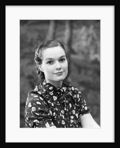 1930s portrait of brunette woman wearing printed blouse half smile mona lisa like beautiful eyes looking at camera by Anonymous