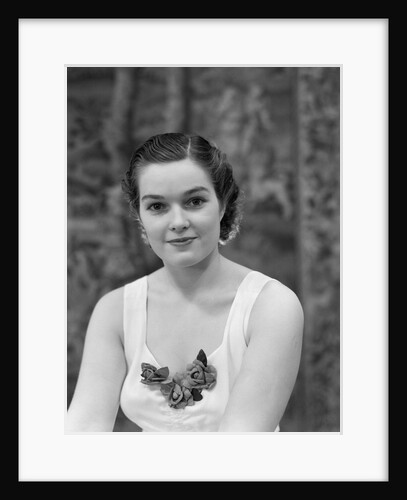 1930s brunette woman wearing white sleeveless formal dress corsage at dÆ’colletage looking at camera by Anonymous