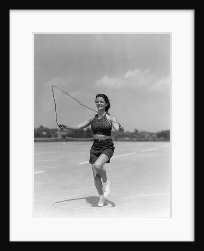 1930s woman jumping rope exercise outdoors wearing polka dot halter top and shorts by Anonymous