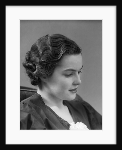 1930s thoughtful brunette woman in profile with finger wavy hair by Anonymous