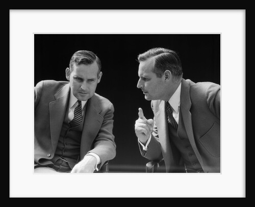 1930s 1940s businessman talking seriously to himself or his twin alter ego by Anonymous