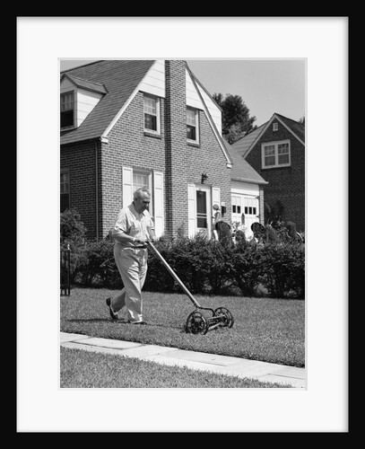 1940s 1950s elderly overweight man pushing lawn mower in front of brick house by Anonymous