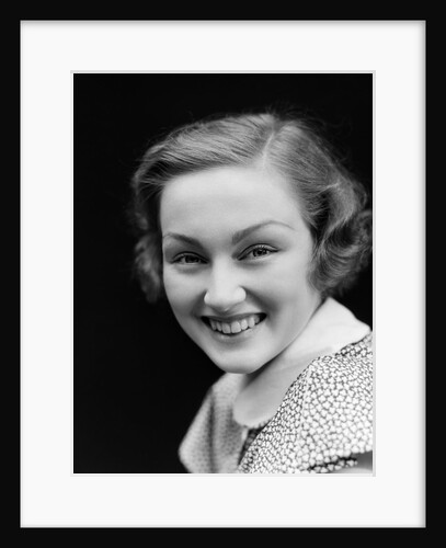 1930s portrait happy young brunette woman wearing print blouse with white collar smiling looking at camera by Anonymous