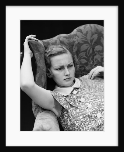 1930s woman sitting slumped position with a worried expression and a furrowed brow by Anonymous
