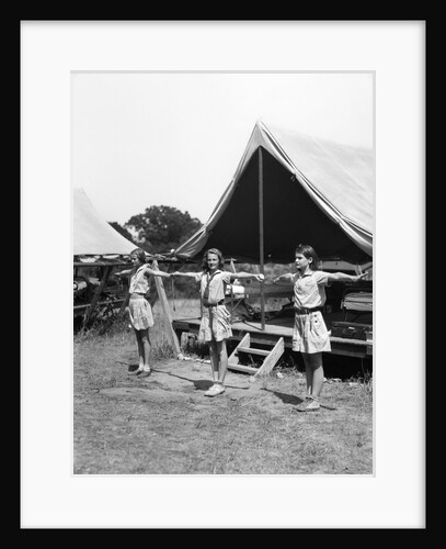 1930s three teen girls doing exercise in a row with arms extended by tent summer camp by Anonymous