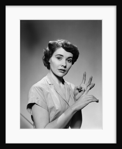 1950s serious woman counting on hands by Anonymous