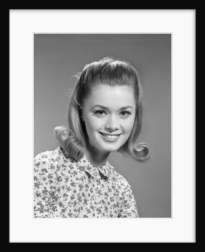 1960s portrait smiling woman wearing print blouse with flip hairdo by Anonymous