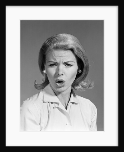 1960s woman blond hair in flip looking at camera mouth open angry mad facial expression by Anonymous