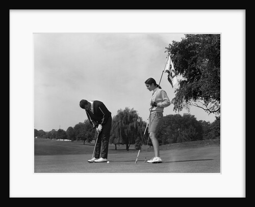 1960s couple man woman put putting by Anonymous