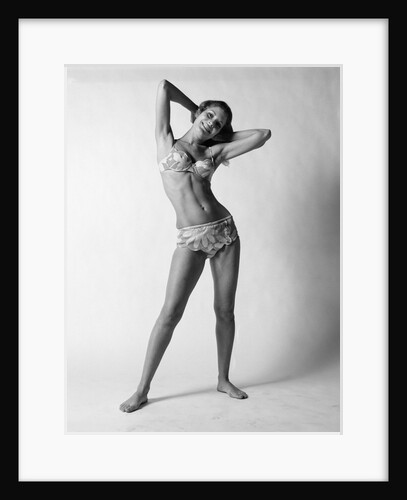 1970s smiling slender young woman standing posing wearing two piece bathing suit looking at camera by Anonymous