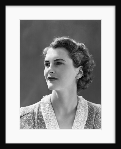 1940s profile portrait brunette woman wearing print dress with lace collar by Anonymous