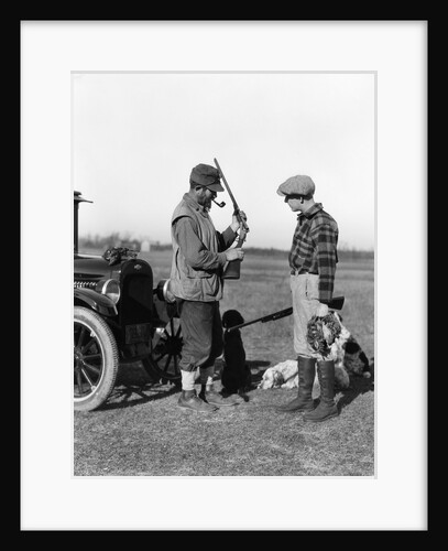 1930s two men hunters by car looking at shotgun with dogs and brace of birds by Anonymous