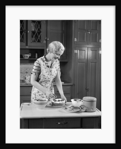 1930s woman in kitchen making strawberry shortcake by Anonymous