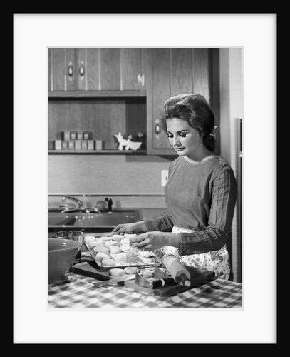 1960s woman housewife baking biscuits in kitchen by Anonymous