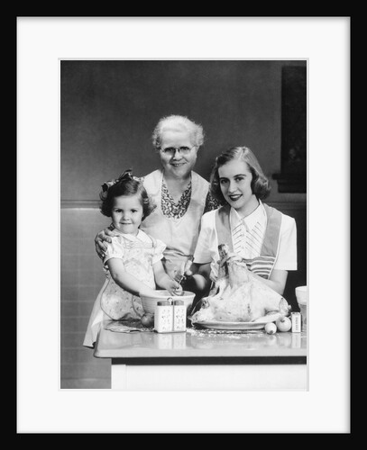 1940s 1950s mother daughter grandmother stuffing turkey by Anonymous