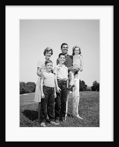 1960s smiling family portrait standing on grass mother father three children by Anonymous