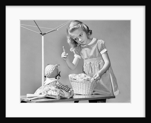 1940s girl shaking her finger at doll over toy laundry basket by Anonymous
