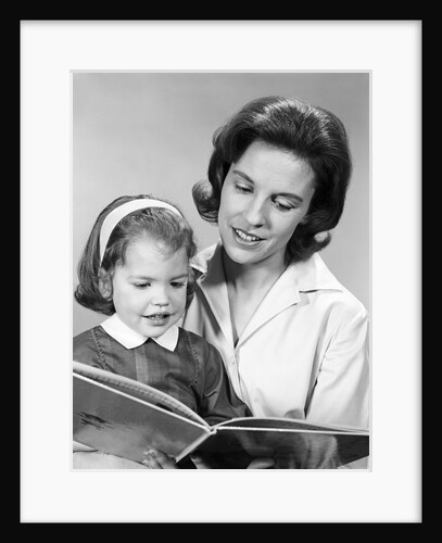 1960s woman reading story book to girl child by Anonymous