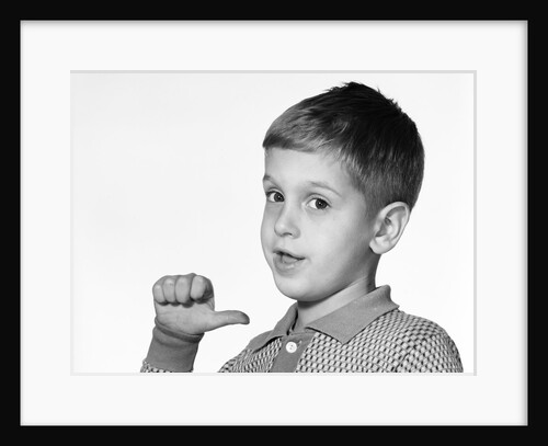1960s young boy pointing to himself with his thumb by Anonymous