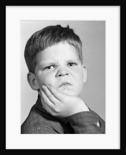 1960s little boy making angry funny facial expression looking at camera by Anonymous