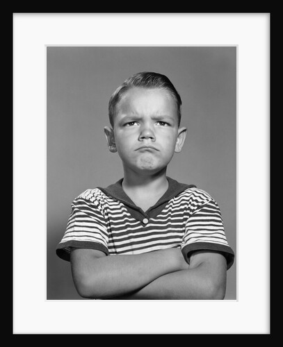 1960s portrait pouting angry boy arms folded against chest striped shirt by Anonymous