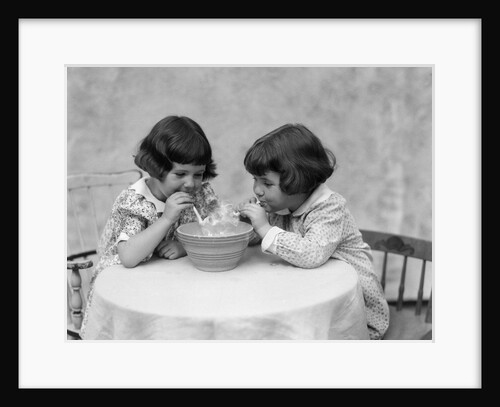 1930s two girls playing blowing soap bubble pipes by Anonymous