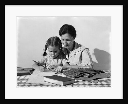 1960s child girl doing homework with parent mother by Anonymous