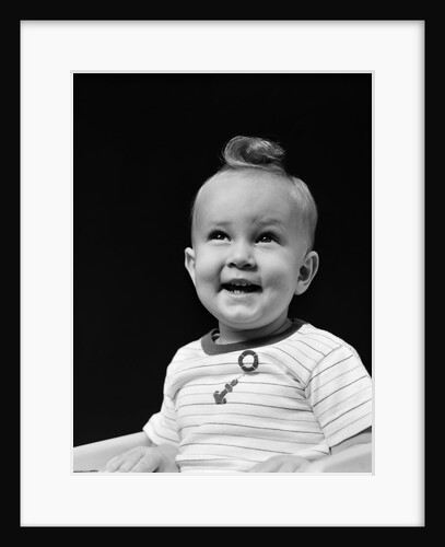 1940s smiling blond boy with big curl on top of head looking up by Anonymous
