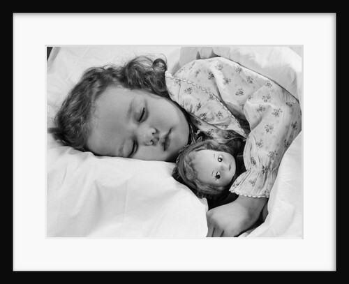 1950s child little girl sleeping in bed with doll by Anonymous
