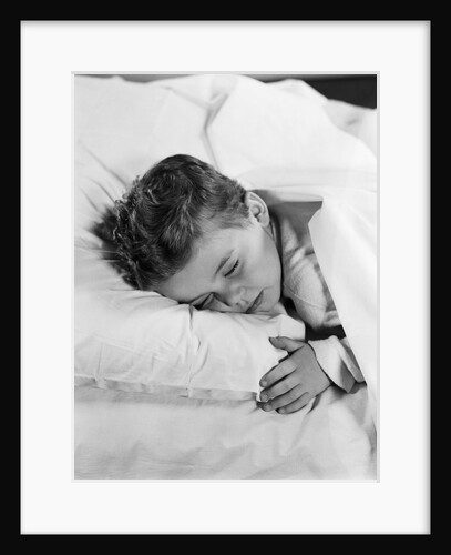 1950s child little boy sleeping in bed by Anonymous