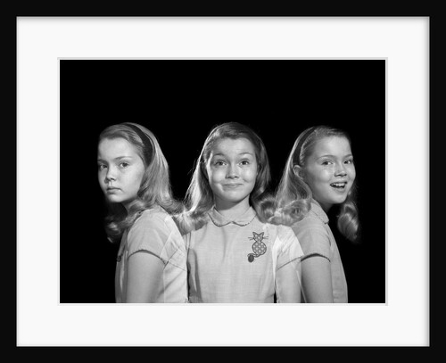 1950s 1960s multiple exposure girl going from happy to sad three facial expressions looking at camera by Anonymous