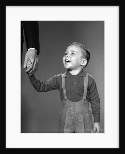 1960s boy holding adult male hand smiling by Anonymous
