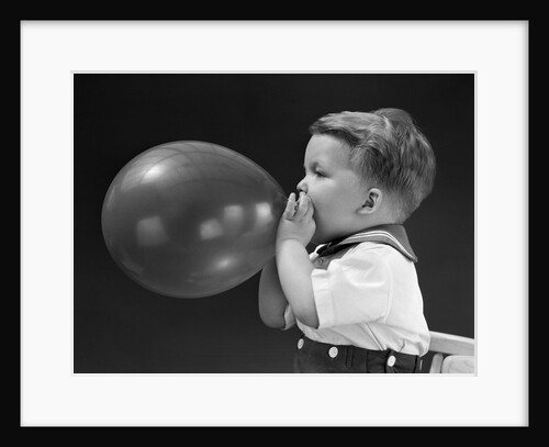 1940s boy blowing up balloon by Anonymous