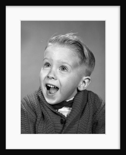 1960s young blond boy with happy surprised facial expression by Anonymous