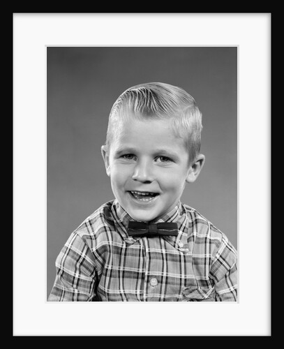 1950s smiling blond boy wearing plaid shirt bow ties looking at camera by Anonymous