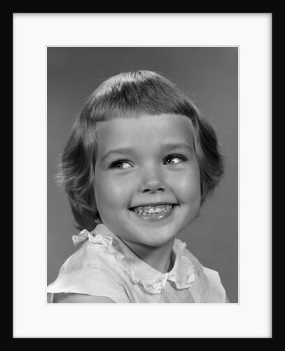 1960s smiling girl looking off to the side by Anonymous
