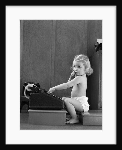 1940s child sitting typing on adding machine funny facial expression by Anonymous