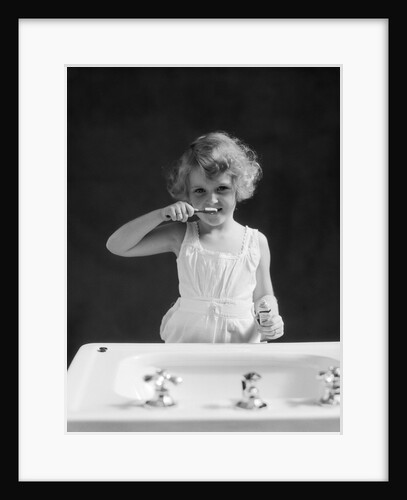 1930s child curly hair blond girl brushing teeth toothbrush looking at camera by Anonymous