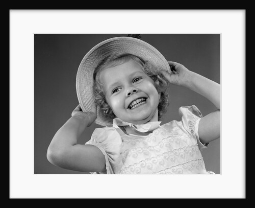 1950s child smiling little girl wearing pretty dress and straw hat by Anonymous