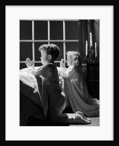 1950s two children praying kneeling night by Anonymous