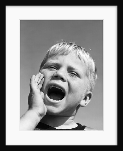 1950s blond boy with eyes closed and hand cupping a wide open mouth shouting by Anonymous