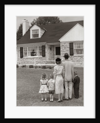 1950s family of five with backs to camera on lawn looking at fieldstone house by Anonymous