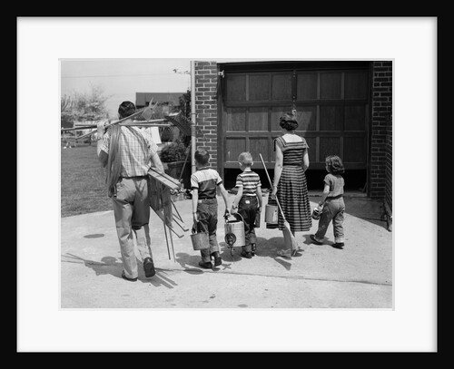 1950s family mother father 3 children from behind carrying gardening home improvement tools equipment by Anonymous