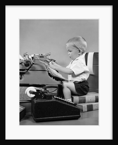 1950s child typing sitting at typewriter by Anonymous
