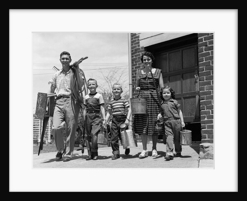 1950s family mother father 3 children happy smiling carrying gardening home improvement tools by Anonymous