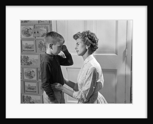1960s sad crying boy rubbing his eyes is comforted or disciplined by his caring mother by Anonymous