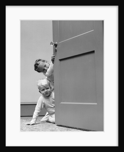 1940s children boy and girl in pajamas peeking around door by Anonymous
