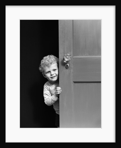 1940s child little boy peeking looking around door by Anonymous