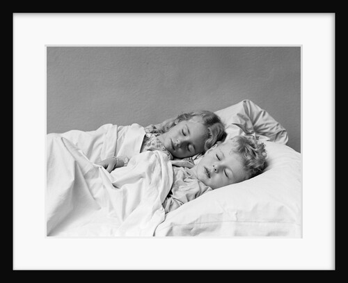 1940s two children boy and girl sleeping in bed by Anonymous