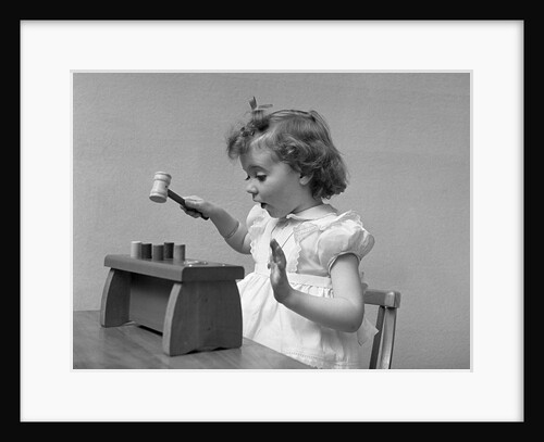 1940s child little girl playing hammering toy game by Anonymous